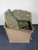 A box containing a quantity of army surplus items.