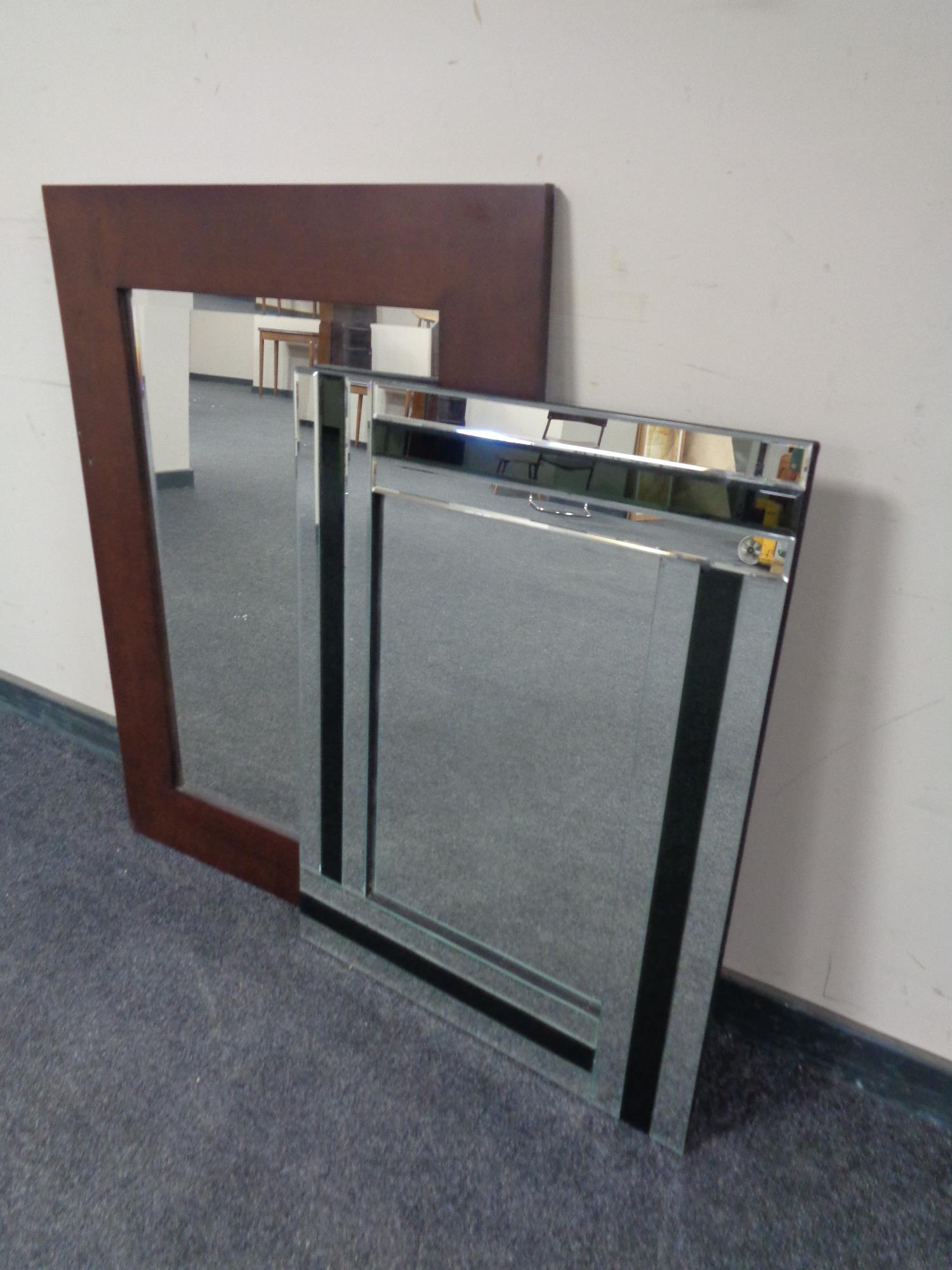 A contemporary wood framed bevel edge mirror together with an all glass framed mirror.