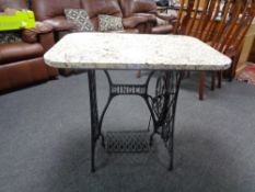 A marble topped table on Singer treadle base.