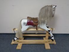 A hand carved wooden rocking horse supplied by The Rocking Horse Shop Ltd, York, with sales receipt,