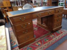 A 19th century twin pedestal desk with brass drop handles and a leather inset panel.