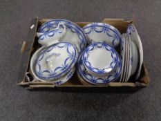 A box containing antique blue and white Empire dinner ware.