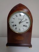 An inlaid mahogany mantel clock by Comitti of London on raised brass feet