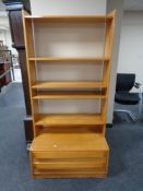 A set of pine open bookshelves fitted two drawers beneath.