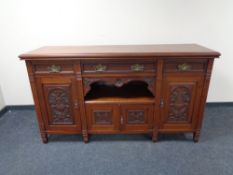 A late 19th century mahogany four door sideboard fitted with three drawers above,