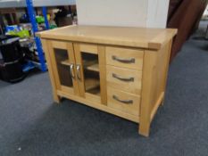 A contemporary pine double door cabinet, fitted three drawers.