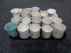 A tray containing a quantity of commemorative mugs,