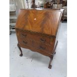 A late 19th century mahogany writing bureau fitted two drawers on claw and ball feet
