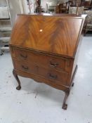 A late 19th century mahogany writing bureau fitted two drawers on claw and ball feet