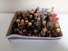 A box containing approximately 45 alcohol miniatures.