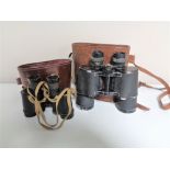 Two sets of early twentieth century leather cased field glasses.