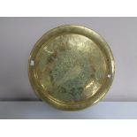 A circular brass Eastern plaque.