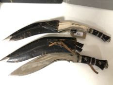 Two Kukri knives in sheaths