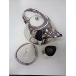 A Georg Jensen three piece tea service comprising teapot with ceramic lid on ceramic stand,