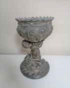A 19th century embossed pot metal goblet with cherub support.