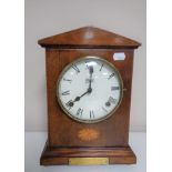 An early twentieth century inlaid mahogany case mantel clock on raised brass feet by Abbey.