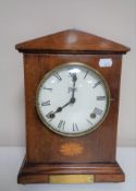 An early twentieth century inlaid mahogany case mantel clock on raised brass feet by Abbey.