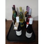A tray containing ten bottles of alcohol including wine, California Chardonnay, etc.