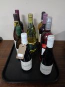 A tray containing ten bottles of alcohol including wine, California Chardonnay, etc.