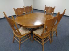 An American style circular extending dining table with leaf together with a set of six high backed