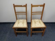 A pair of Edwardian oak bedroom chairs.
