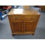 A 20th century oak double door cupboard fitted with drawer.