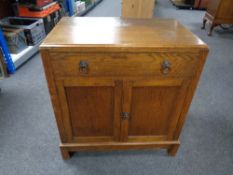 A 20th century oak double door cupboard fitted with drawer.