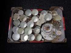 A box containing commemorative china, cups, mugs, etc.