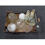 A box containing assorted glass light shades together with a pair of marble table lamps.