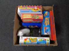 A box containing a china figure of a cat together with a quantity of games to include Towme,