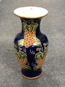 A large glazed pottery vase of grape leaf design.