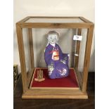 A contemporary matte-glazed Japanese doll/ornament,