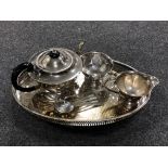 A silver plated gallery tray on raised feet together with a three piece Sheffield Plate tea service