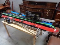 A large quantity of assorted skis and ski poles to include Rossignol Fischer etc together with