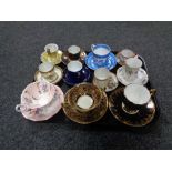 A tray containing antique and later teacups, coffee cans and saucers to include Willow Pattern,