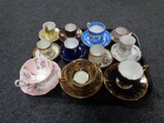 A tray containing antique and later teacups, coffee cans and saucers to include Willow Pattern,