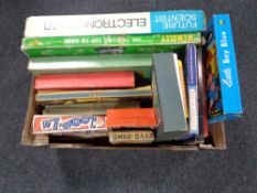 A box containing vintage board games and toys to include a future scientist electronics lab,