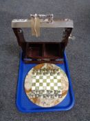 A Tantalus together with an onyx chess board with metal pieces.