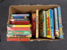 A box containing vintage board games and toys to include Pop Eye, Tarzan, Chemistry set etc.