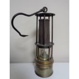 A vintage miner's lamp.