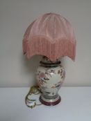 A floral pottery table lamp with shade.