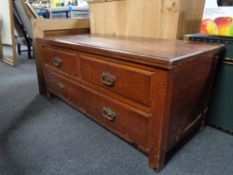 An Edwardian three drawer chest with brass drop handles.
