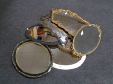 Seven assorted shaped and oval framed mirrors.