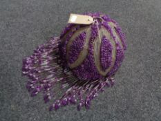 A purple beaded glass light shade