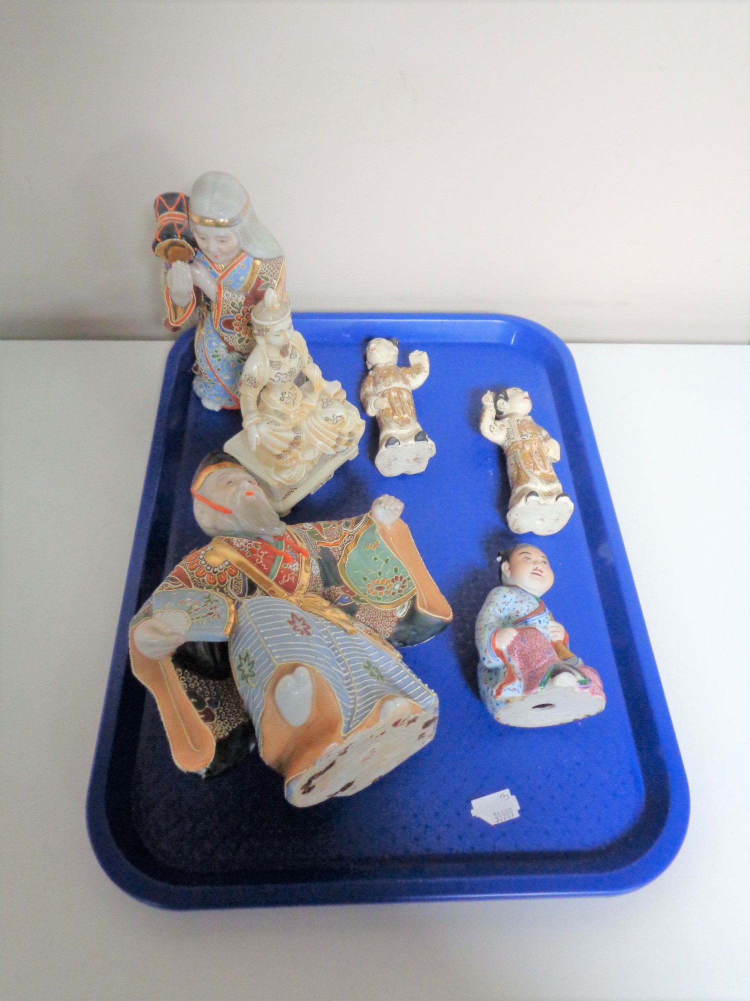 A tray containing six oriental figures.
