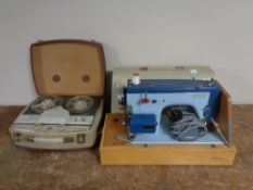 A cased Jones electric sewing machine together with a vintage Fidelity reel to reel player.