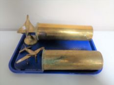 Two brass ammunition shells together with two further brass ornaments, airplanes.