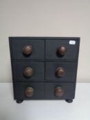 A contemporary six drawer chest with pine knob handles.