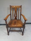 An Edwardian oak armchair