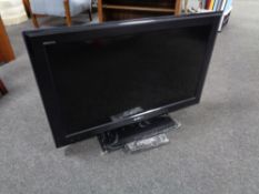 A Sony Bravia 32 inch LCD TV with lead and remote.